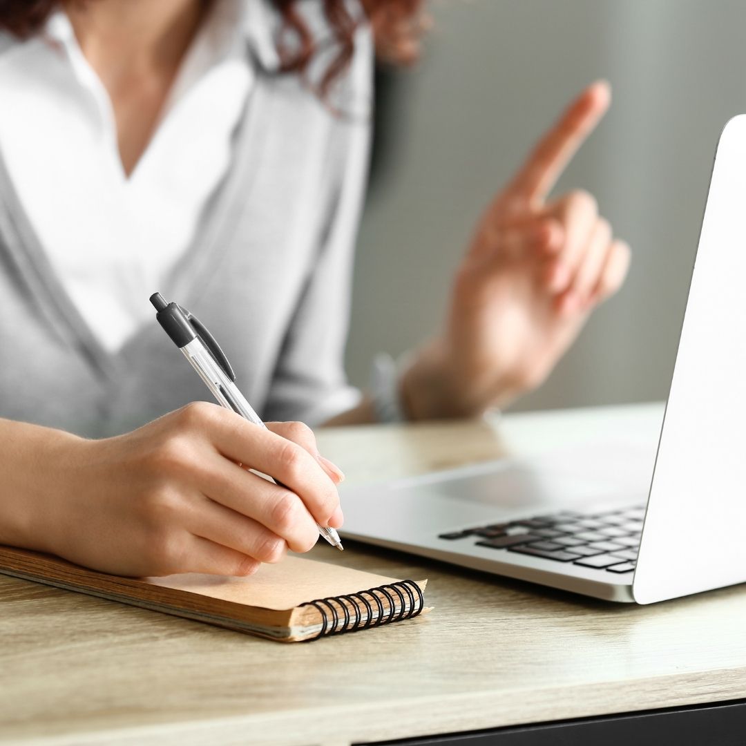 A woman working at a computer.
